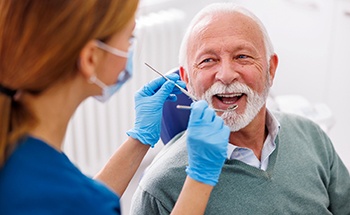 Man smiles at dentist