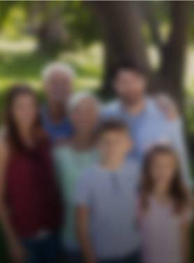 Three generations of family smiling outdoors image blurred