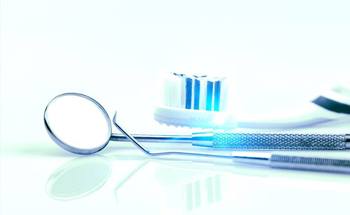 Dental instruments next to toothbrush