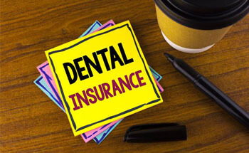 Dental insurance written on a post it note
