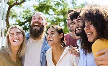 Dental implants patient in Woodstock smiling with friends