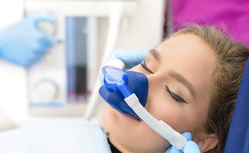 Woman receiving nitrous oxide sedation in dental chair