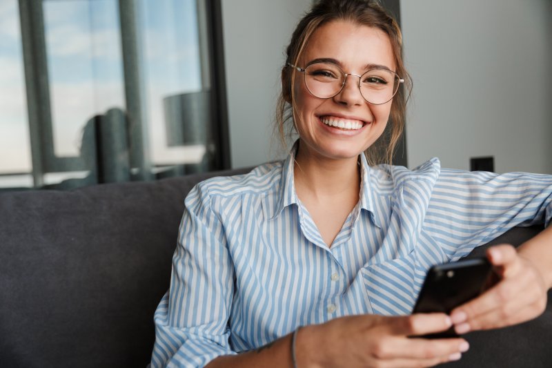 person with nice teeth thanks to dental implants smiling